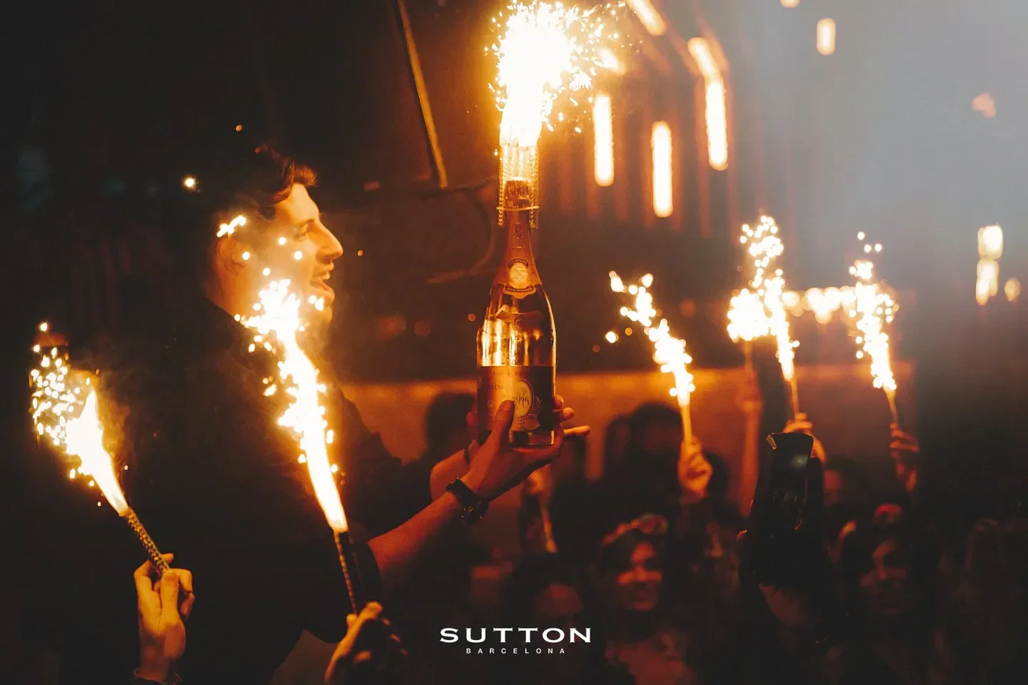 Sparkling celebration at Sutton Barcelona nightclub, a bottle of champagne with sparklers.
