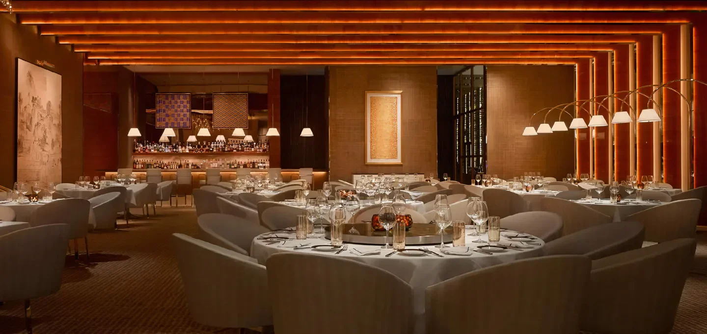 Elegant dining room at SW Steakhouse at Wynn Palace Macau, with bar in background.