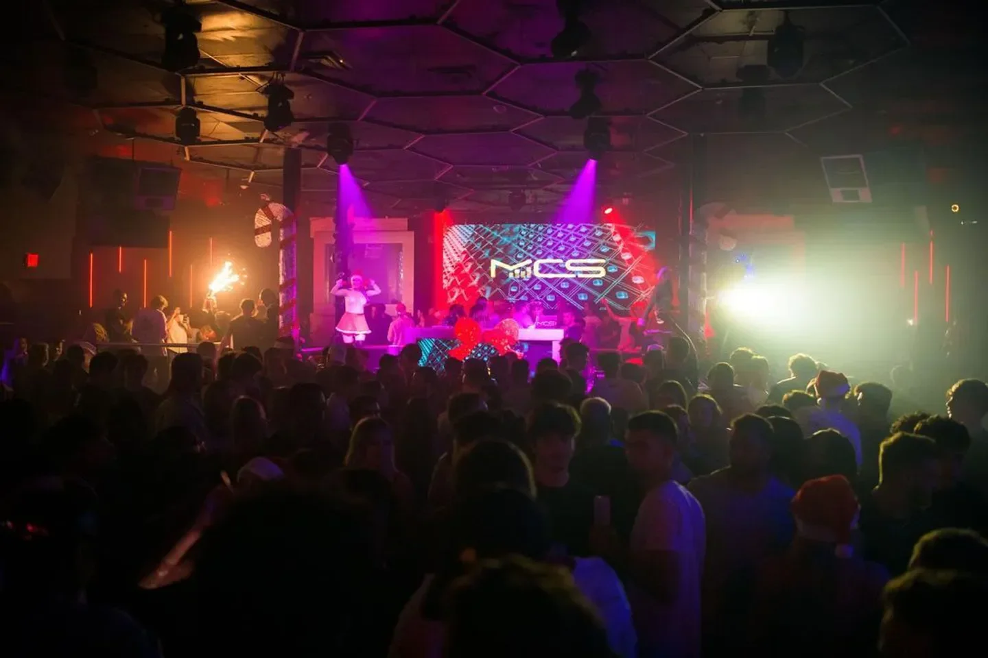 Energetic crowd at Sway Nightclub in Miami enjoying a live performance and lights.