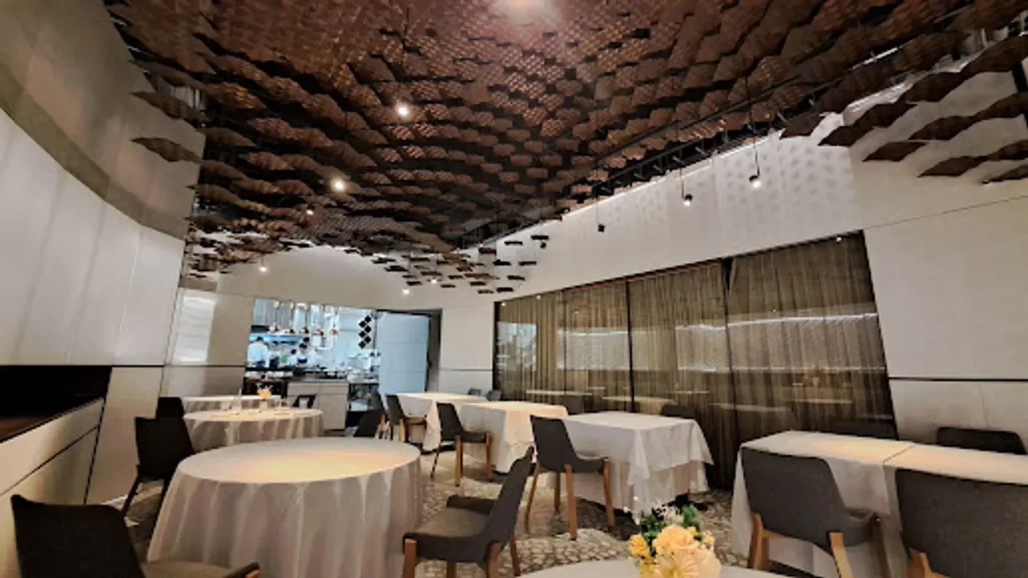 Interior of Taïrroir restaurant in Taipei with unique ceiling design and elegant dining.
