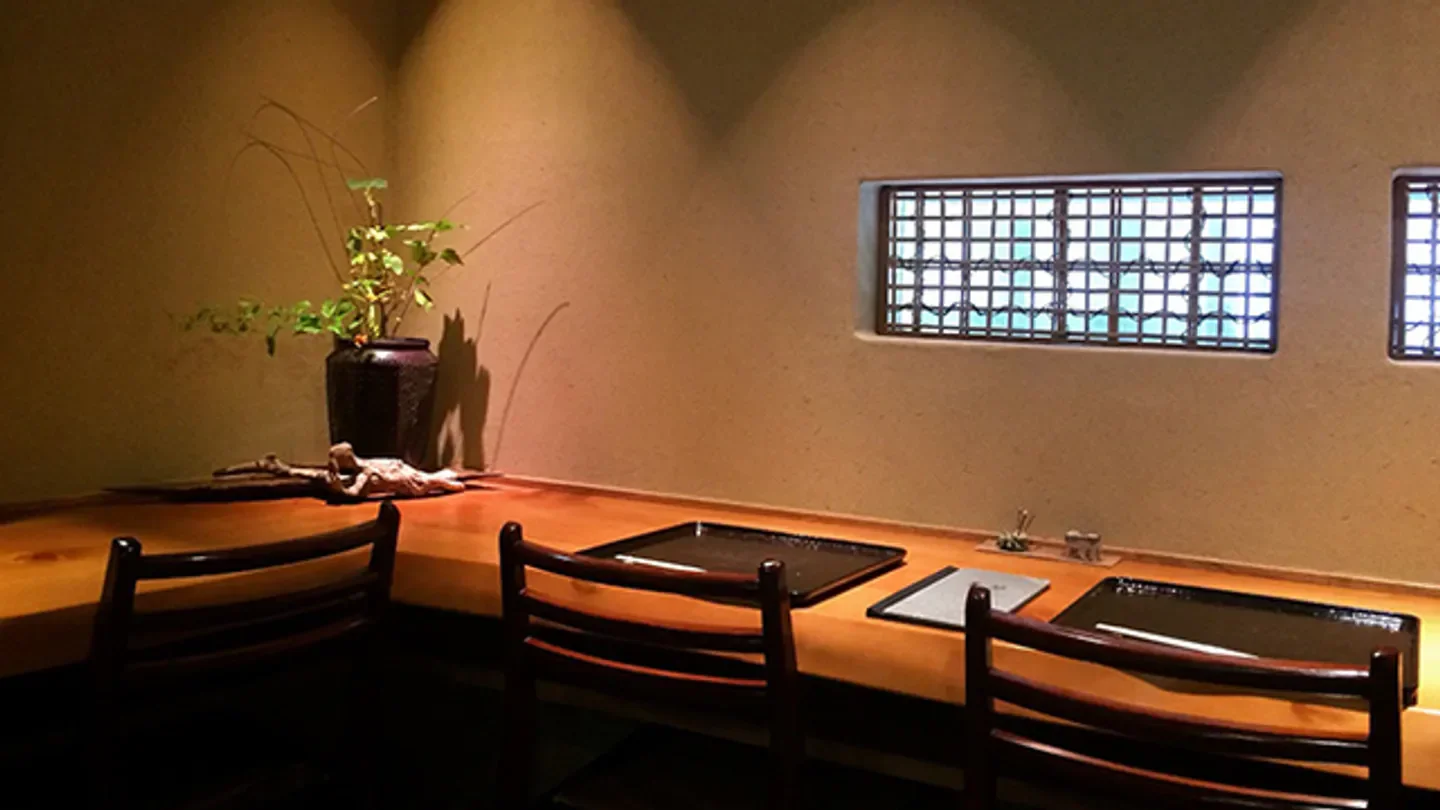 Interior dining at Tamawarai restaurant in Tokyo, showcasing minimalist design and a serene atmosphere.