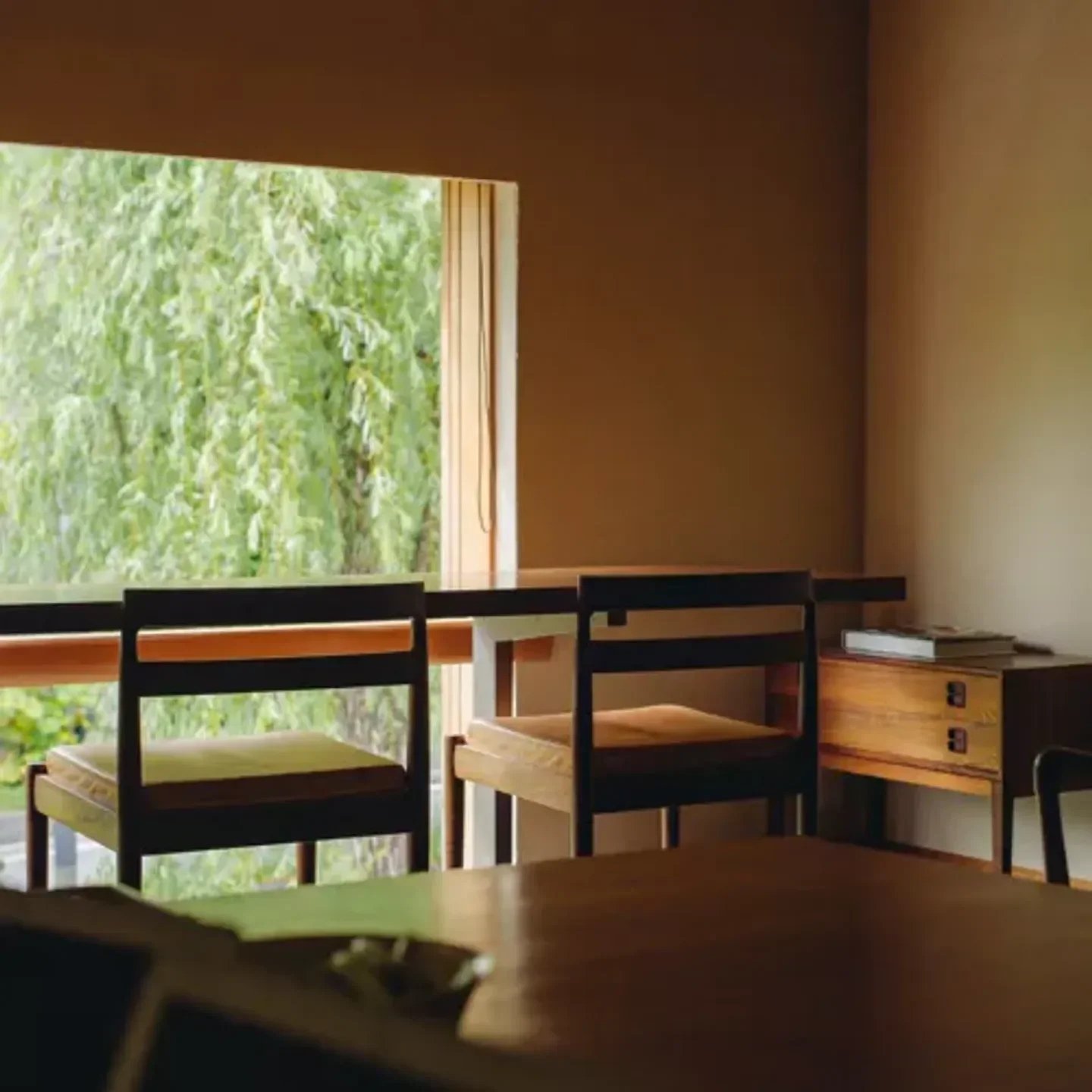 Interior of Tan restaurant in Kyoto, featuring wood furnishings and a scenic view.