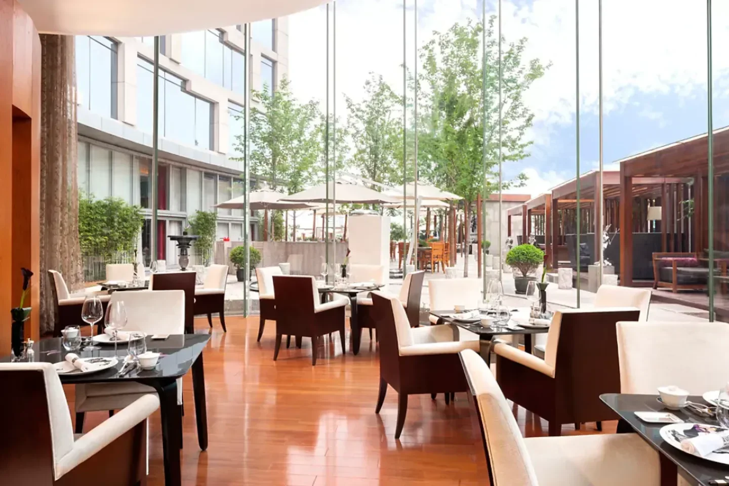 Elegant dining at T'ang Court in Shanghai, with a view of the outdoor patio.