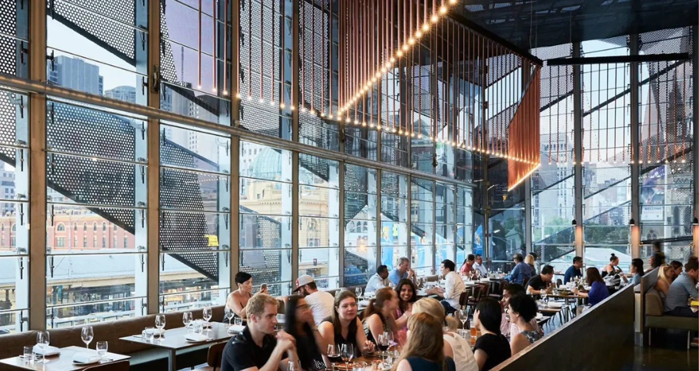 Stylish interior of Taxi Kitchen, a popular Melbourne restaurant, with city views and dining