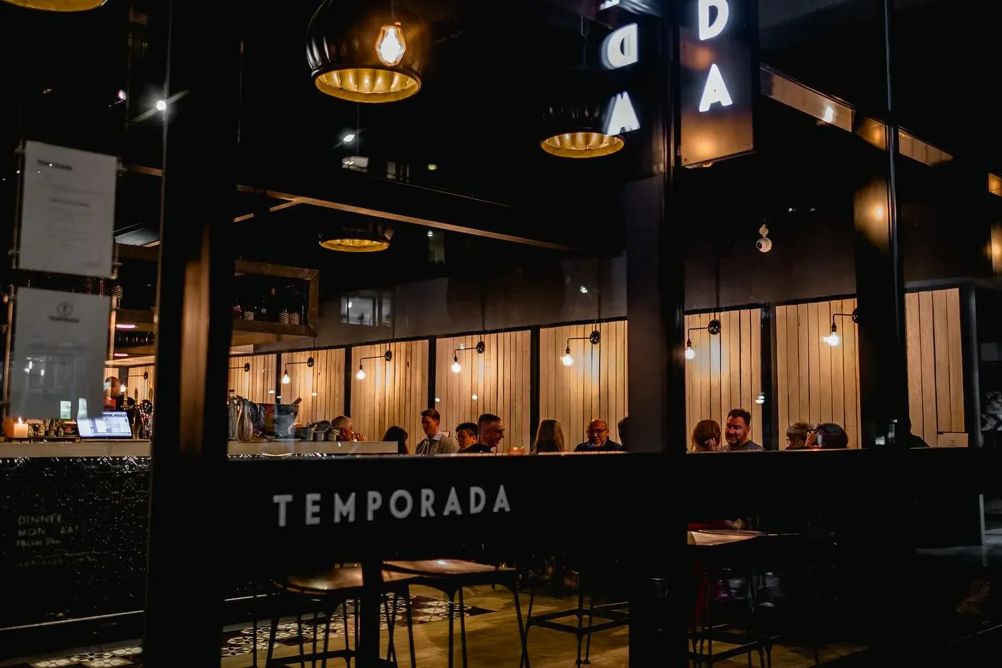 Cozy interior of Temporada restaurant in Canberra, showcasing dining area with soft lighting.