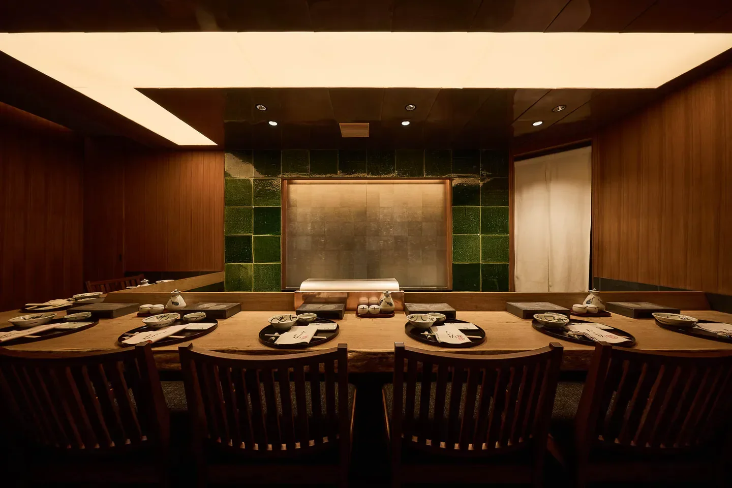 Interior dining space at Ten Yokota restaurant in Tokyo with elegant wooden details and settings