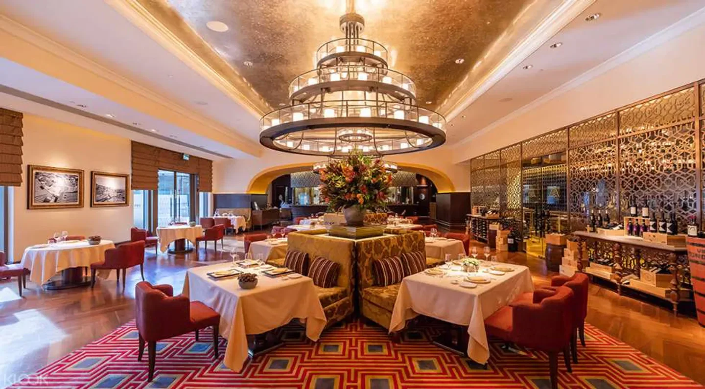 Elegant interior of Terrazza restaurant in Macau with chandeliers and tables set.