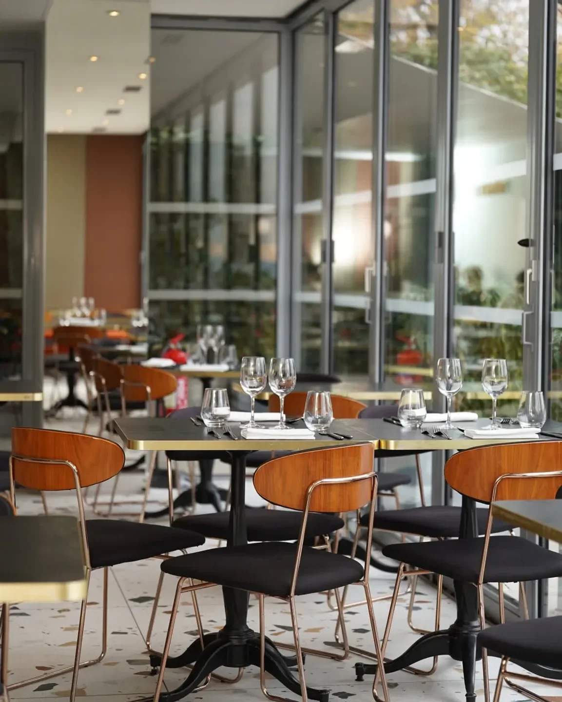 Interior of Têtedoie restaurant in Lyon, featuring stylish tables and chairs.