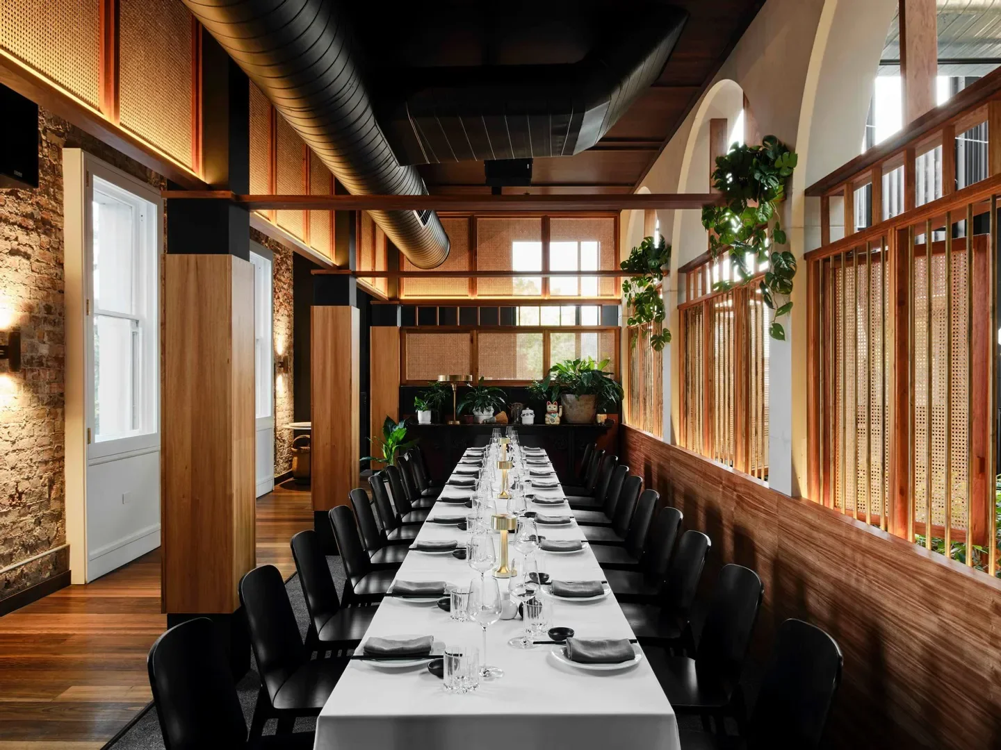Interior dining at The Albert Park Hotel in Melbourne, with a long table set.