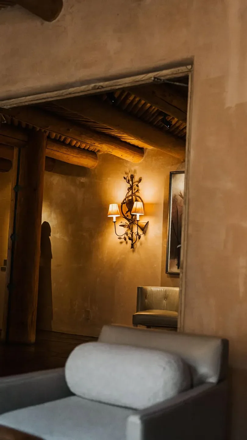 Cozy interior at The Anasazi restaurant in Santa Fe, featuring art and lighting.