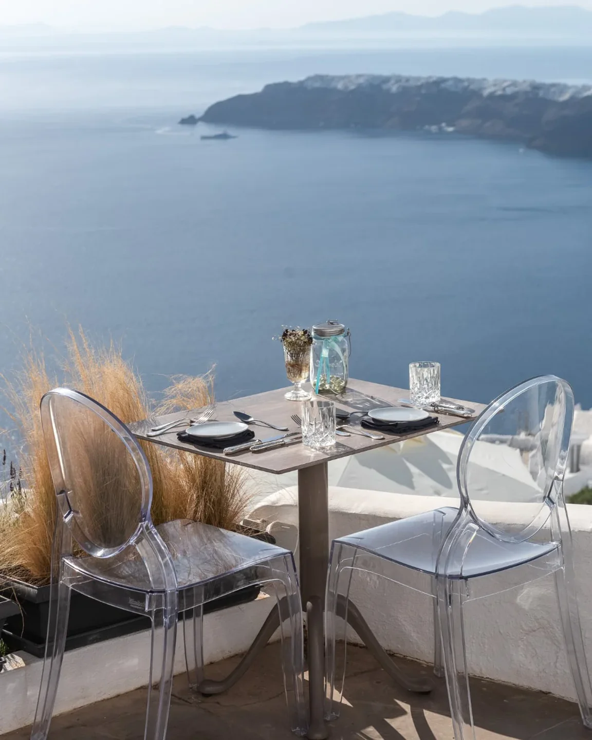 The Athenian House restaurant's outdoor seating with a stunning ocean view, ideal for a romantic dinner.