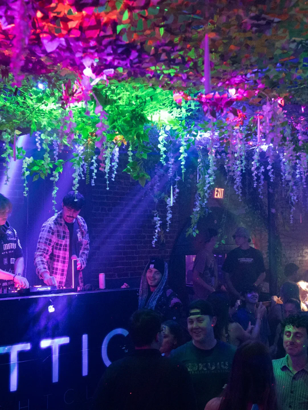 Inside The Attic nightclub in Orlando with vibrant lights and people enjoying music.