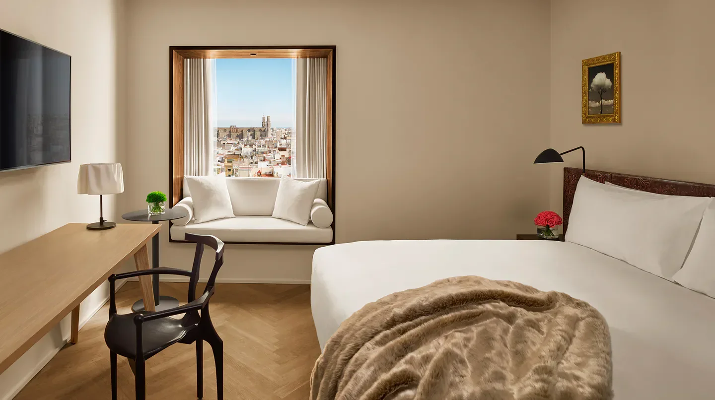 Cozy bedroom at The Barcelona EDITION hotel with a view of Barcelona cityscape