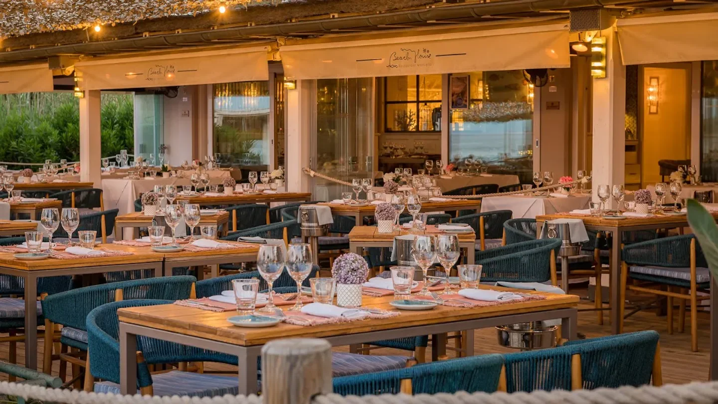 Tables set for dinner at The Beach House restaurant in Marbella, with elegant decor