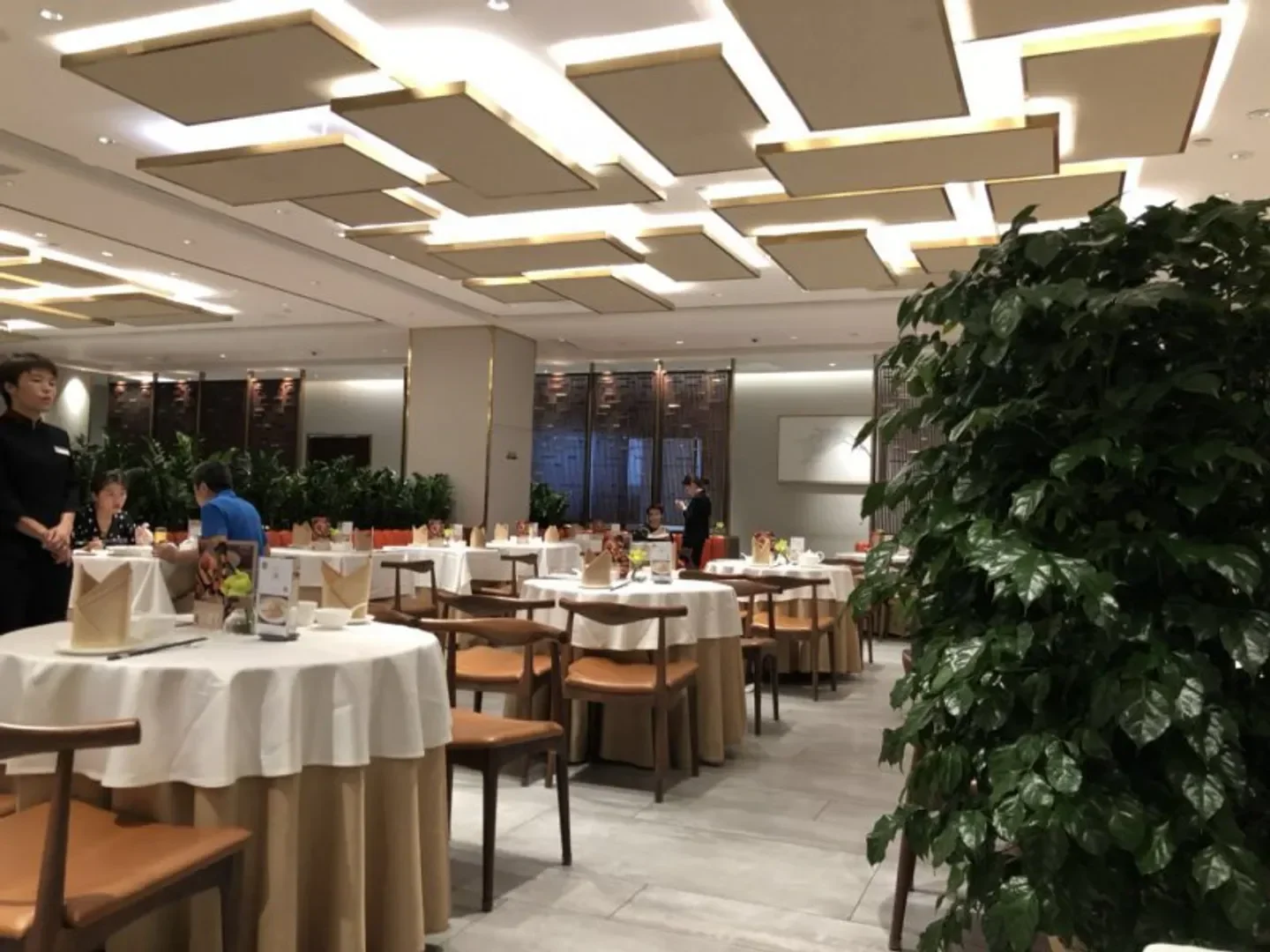 Interior of The Beijing Kitchen (Jianguo Road) in Beijing, featuring dining tables and decor.