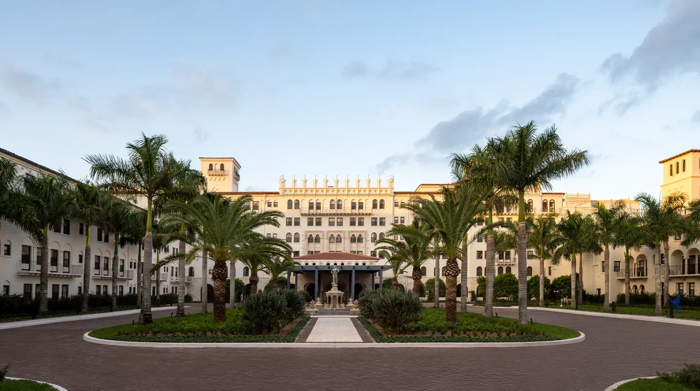 The Boca Raton in Palm Beach, hotel entrance with palm trees and fountain.
