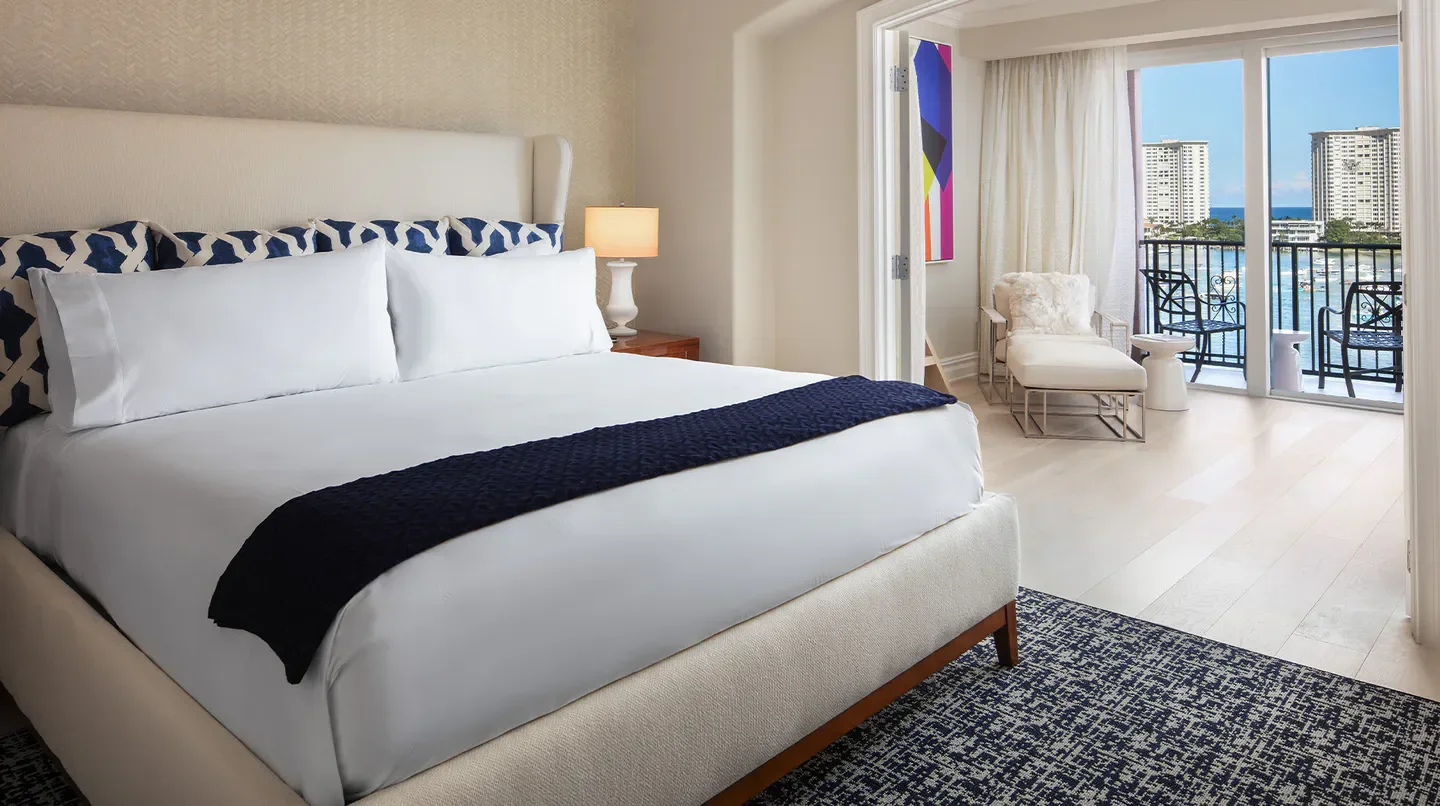 Luxury bedroom at The Boca Raton Yacht Club in Palm Beach, with balcony overlooking the ocean