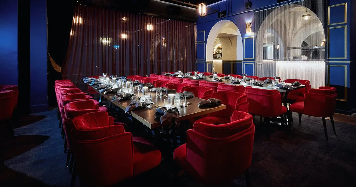 Interior of The Boom Boom Room restaurant in Brisbane with red chairs and tables set