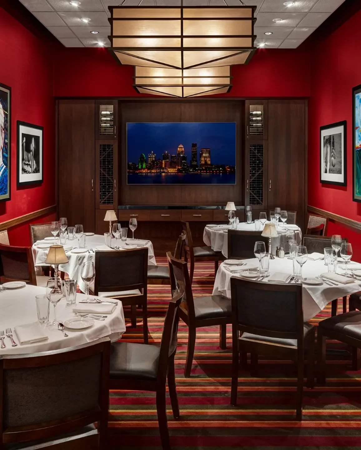 Dining room at The Capital Grille in Orlando, featuring a city view on the TV.