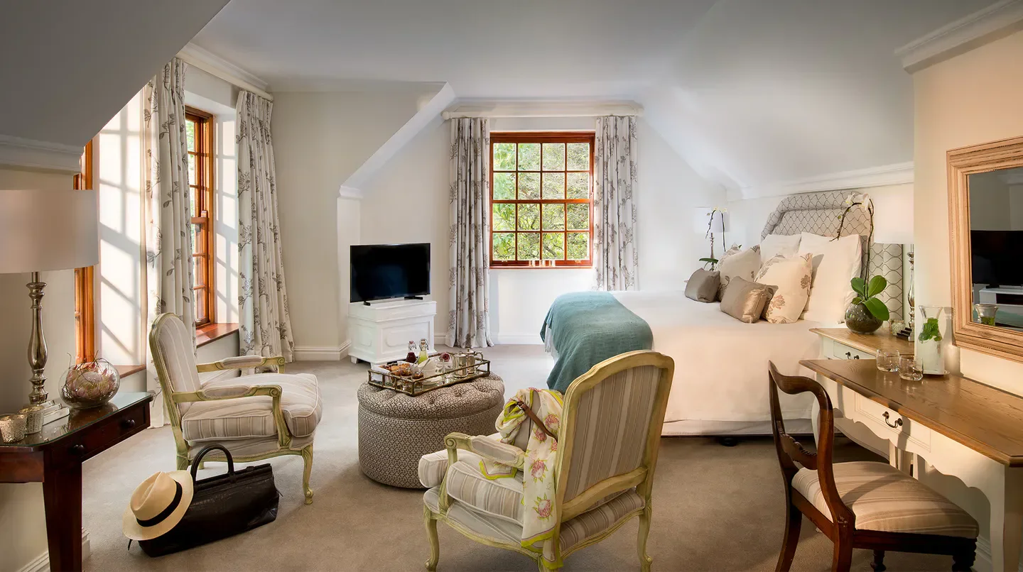 Elegant bedroom at The Cellars-Hohenort in Cape Town, with natural light and stylish decor.