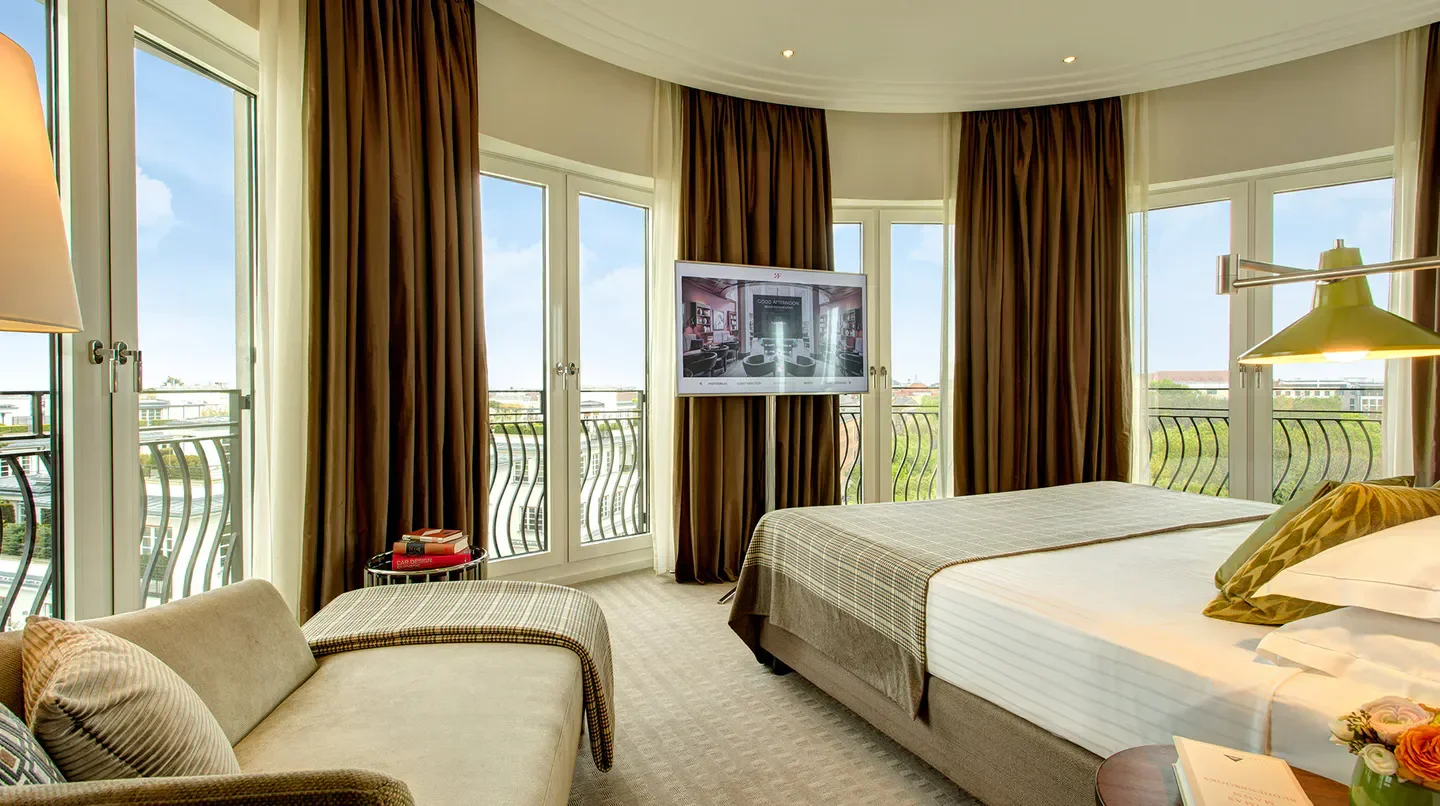 Elegant hotel room at The Charles Hotel, a Rocco Forte Hotel in Munich with balcony view.