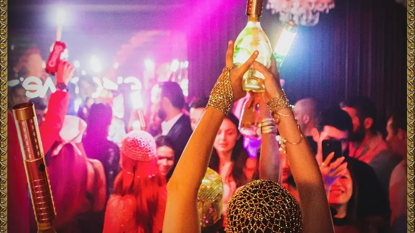 Champagne celebration at The Circus Club in Geneva. Party-goers enjoying a glamorous nightclub scene.
