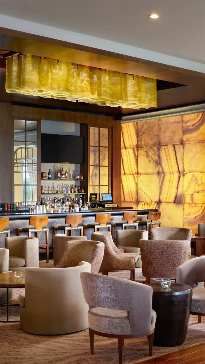 Elegant bar and lounge at The Club Grill in Cancun, featuring stylish seating and ambiance