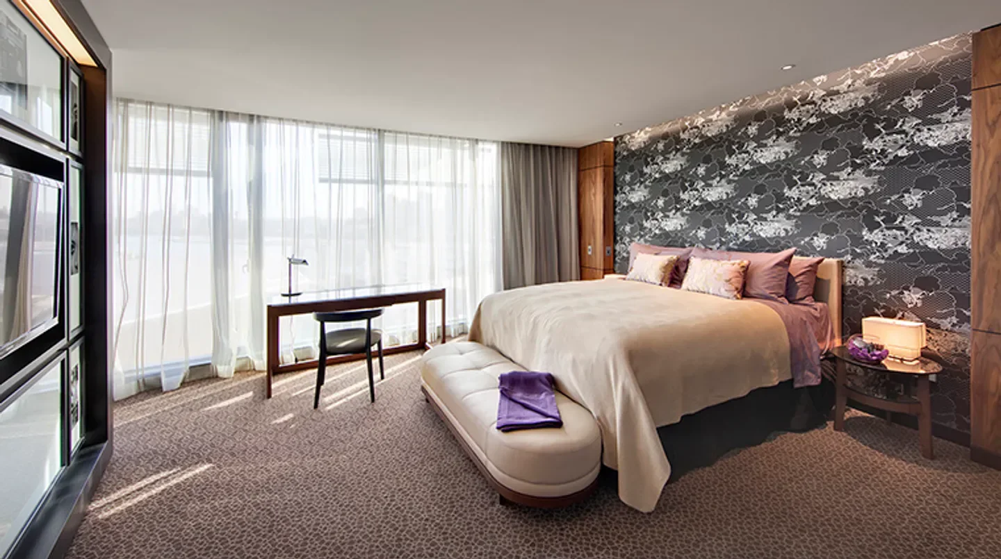Luxury bedroom at The Darling hotel in Sydney, with stylish decor and large windows.