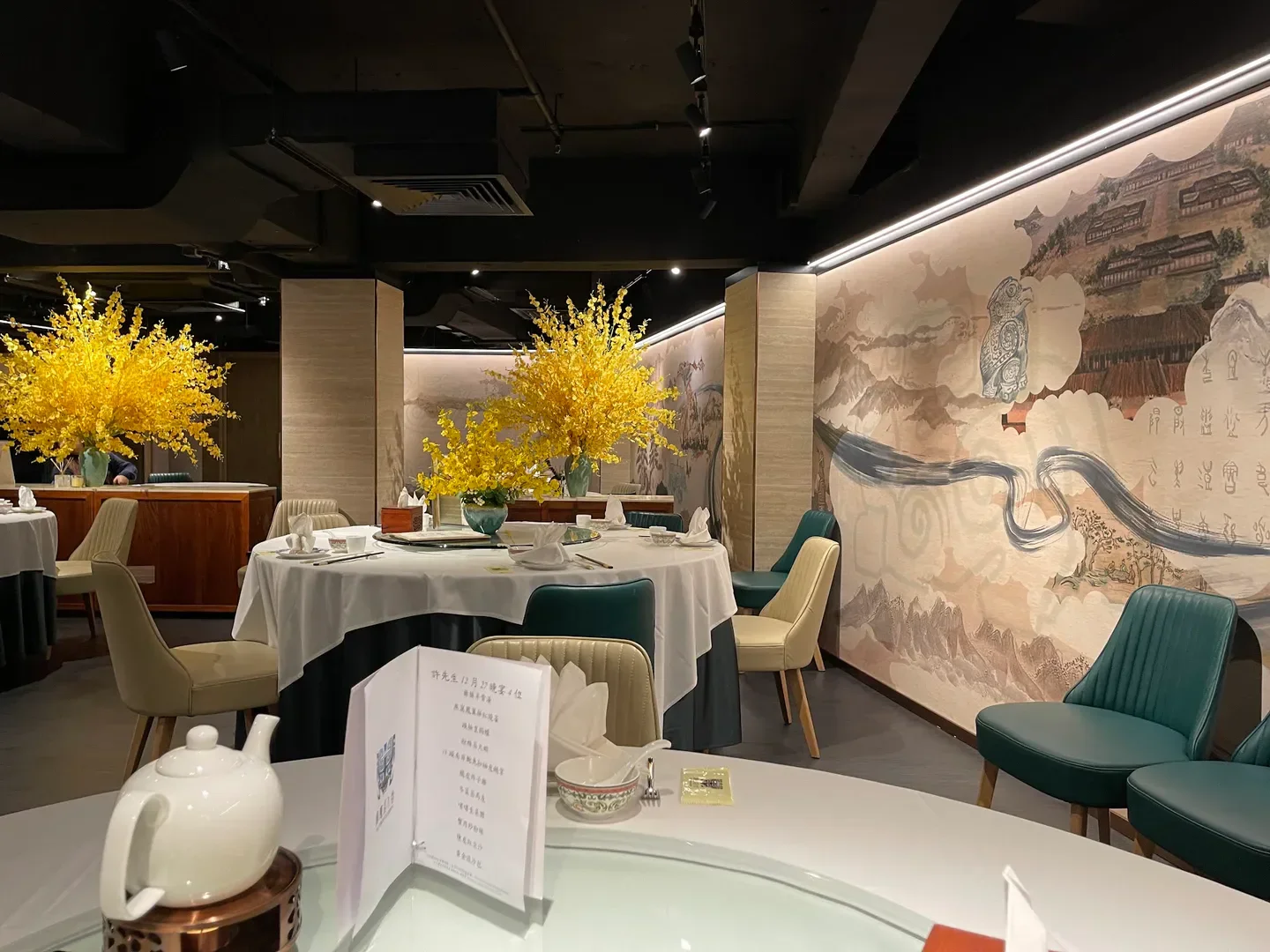 Elegant interior of The Demon Celebrity restaurant in Hong Kong, featuring beautiful floral arrangements.