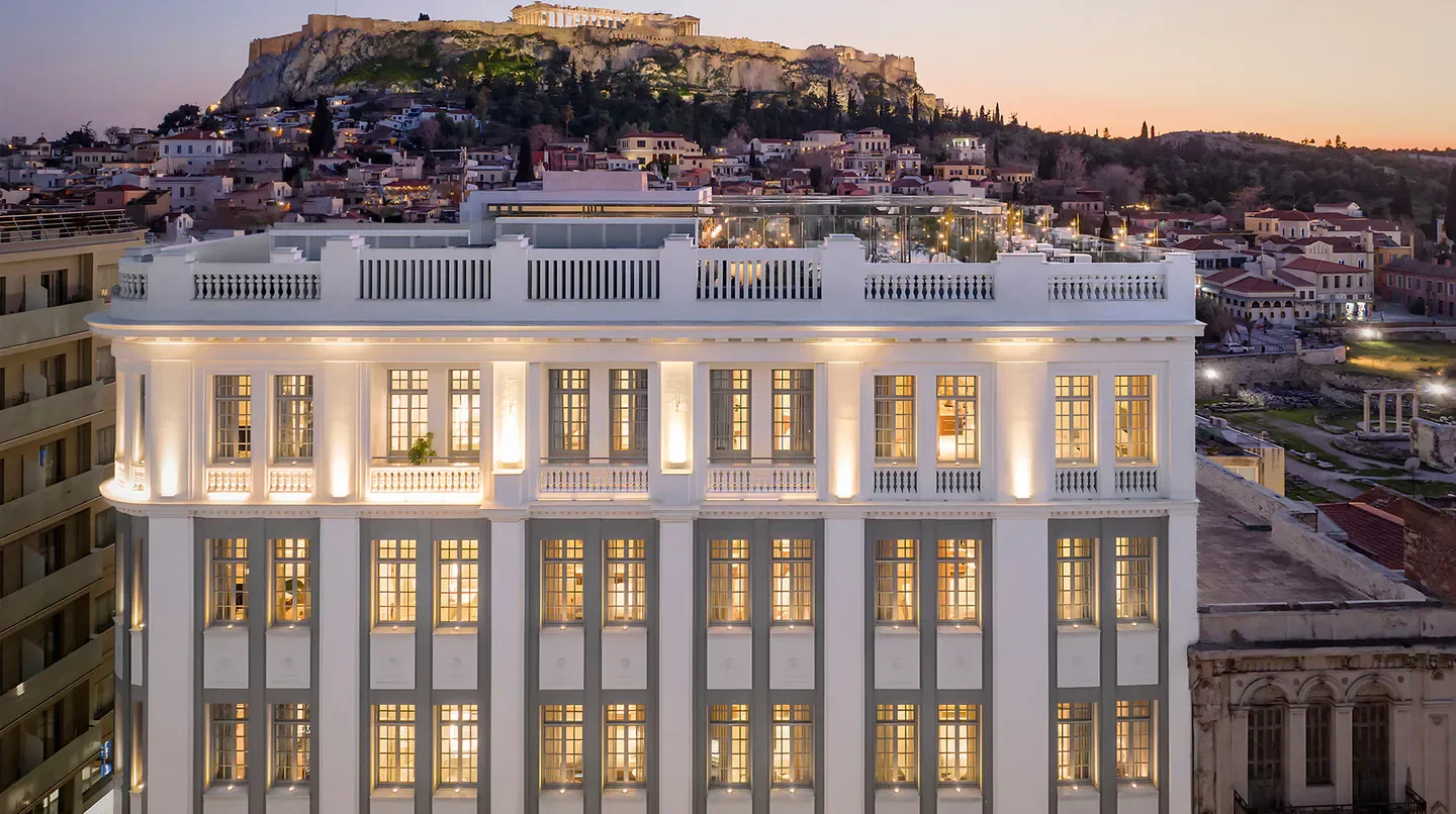 Exterior of THE DOLLI at Acropolis, a hotel in Athens, with the Acropolis in the background.