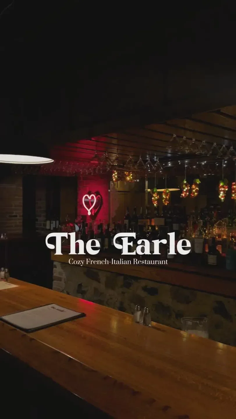 Cozy bar interior at The Earle Restaurant in Ann Arbor, with elegant ambiance and heart neon sign.