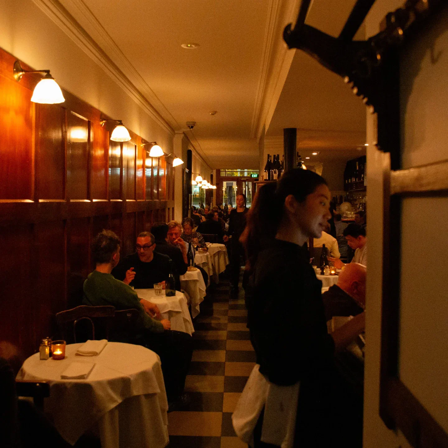 Cozy interior of The European restaurant in Melbourne, with dining tables and soft lighting.