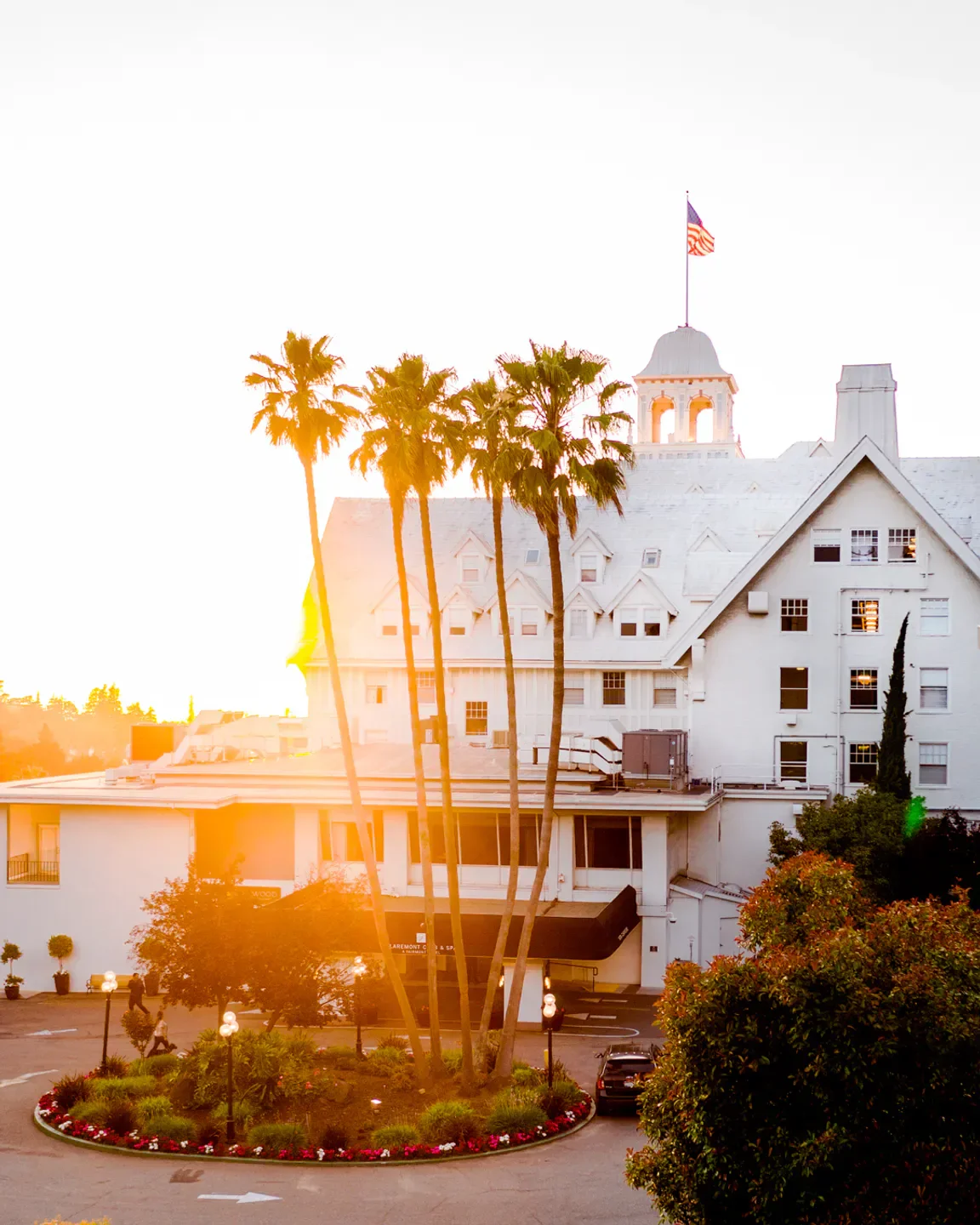 Exterior view of The Fairmont Spa at the Claremont in Napa Valley with palm trees.