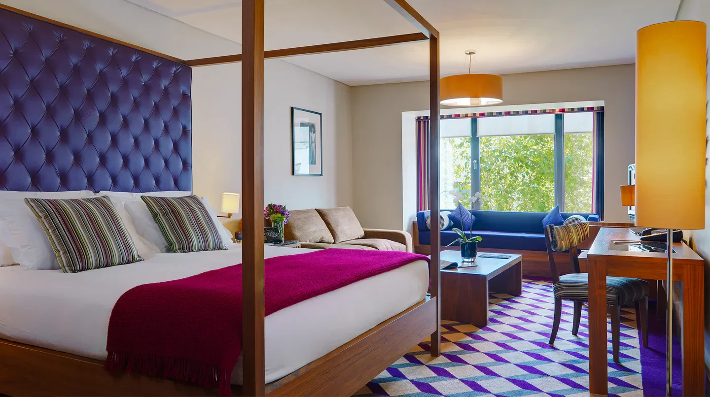 Luxury bedroom at The Fitzwilliam Hotel Dublin, featuring a plush bed and city views.