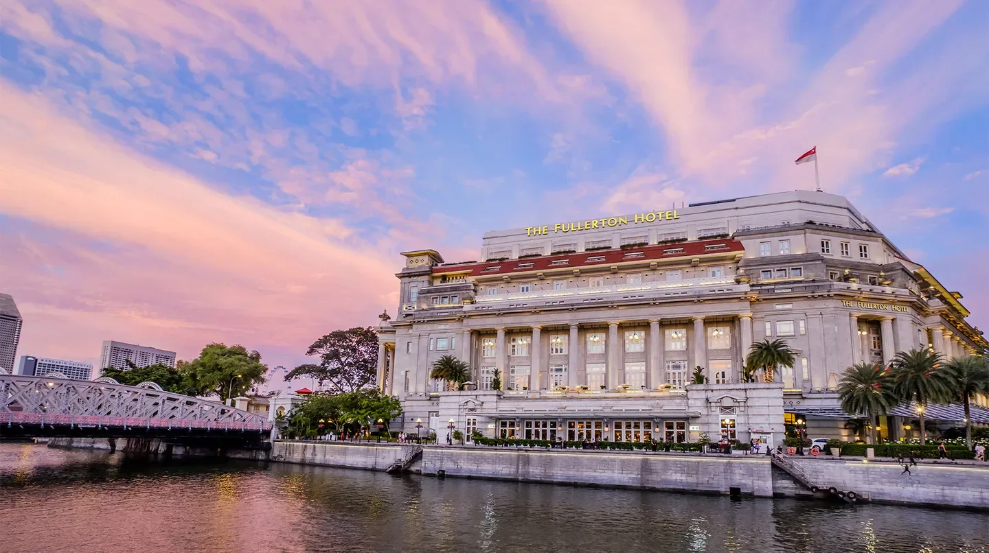 The Fullerton Hotel Singapore at sunset, a luxury hotel in Singapore, by the river
