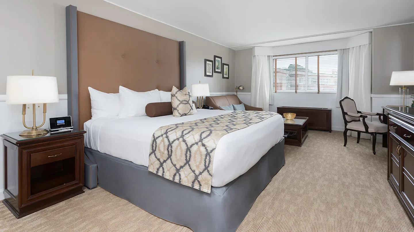 Cozy hotel room at The Garden City Hotel in Nantucket, featuring a large bed and decor