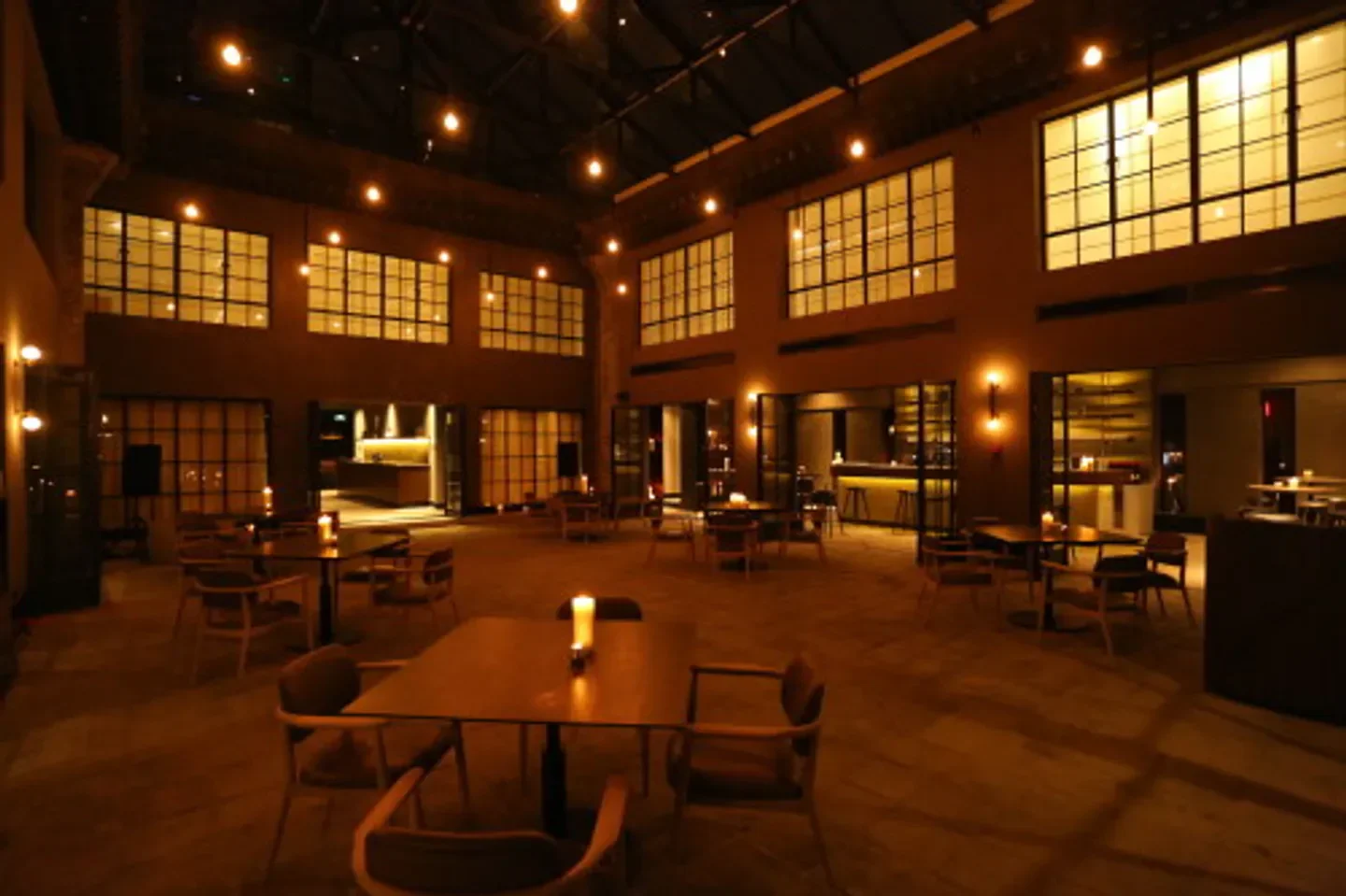 Interior of The Georg restaurant in Beijing, featuring tables, chairs, and warm lighting.