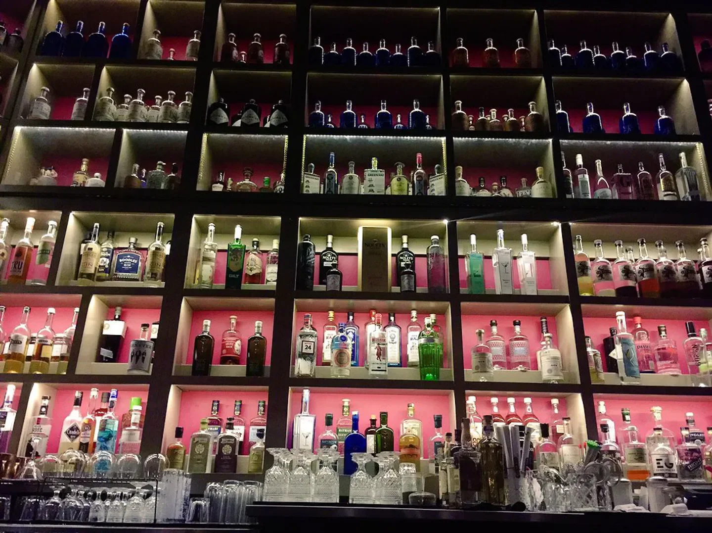 Shelves filled with various gin bottles at The Gin Room in St. Louis.