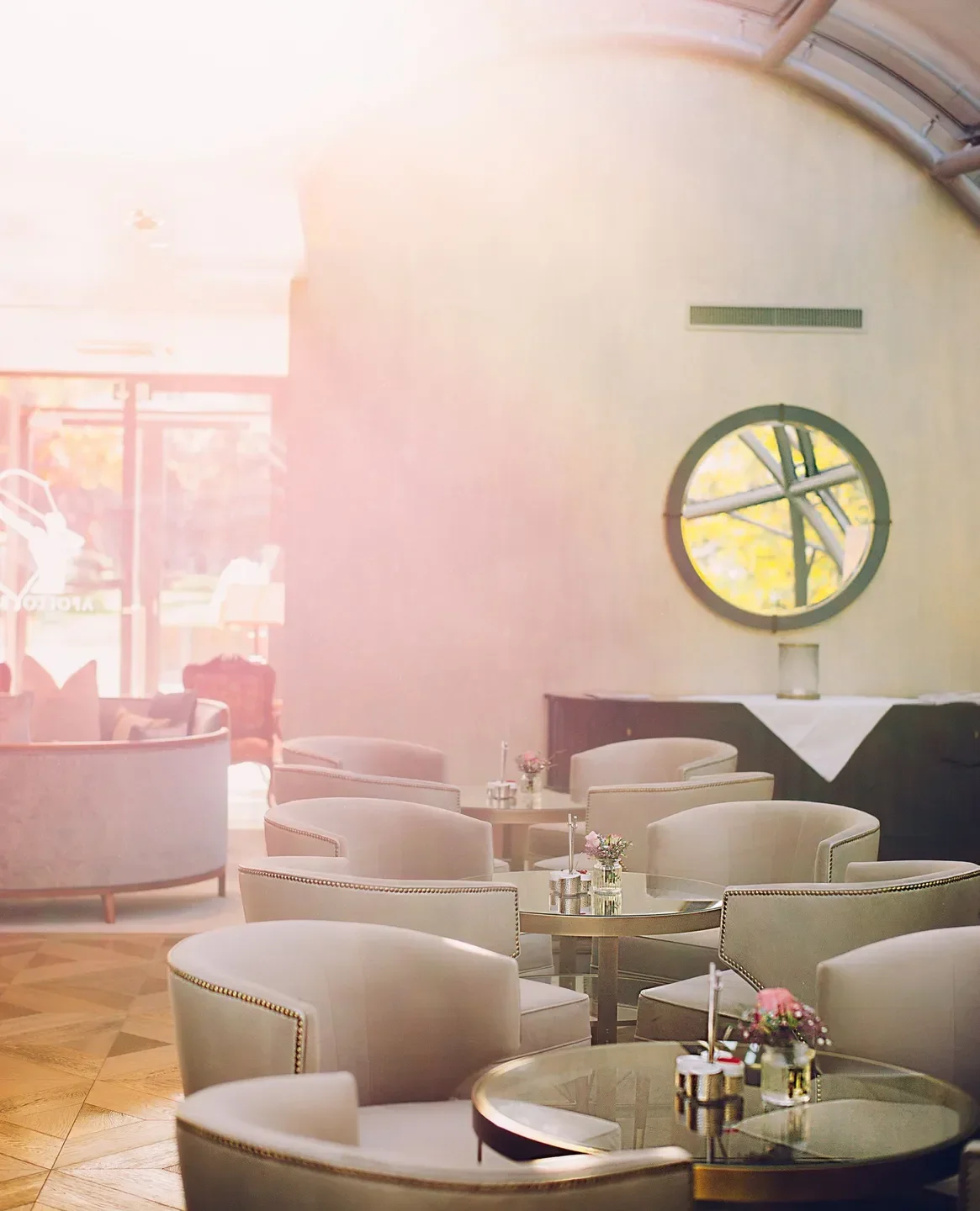 Interior of The Glass Garden restaurant in Salzburg with elegant seating and tables