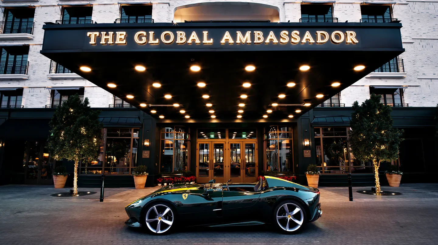 Luxury car parked outside The Global Ambassador hotel in Phoenix, Arizona.