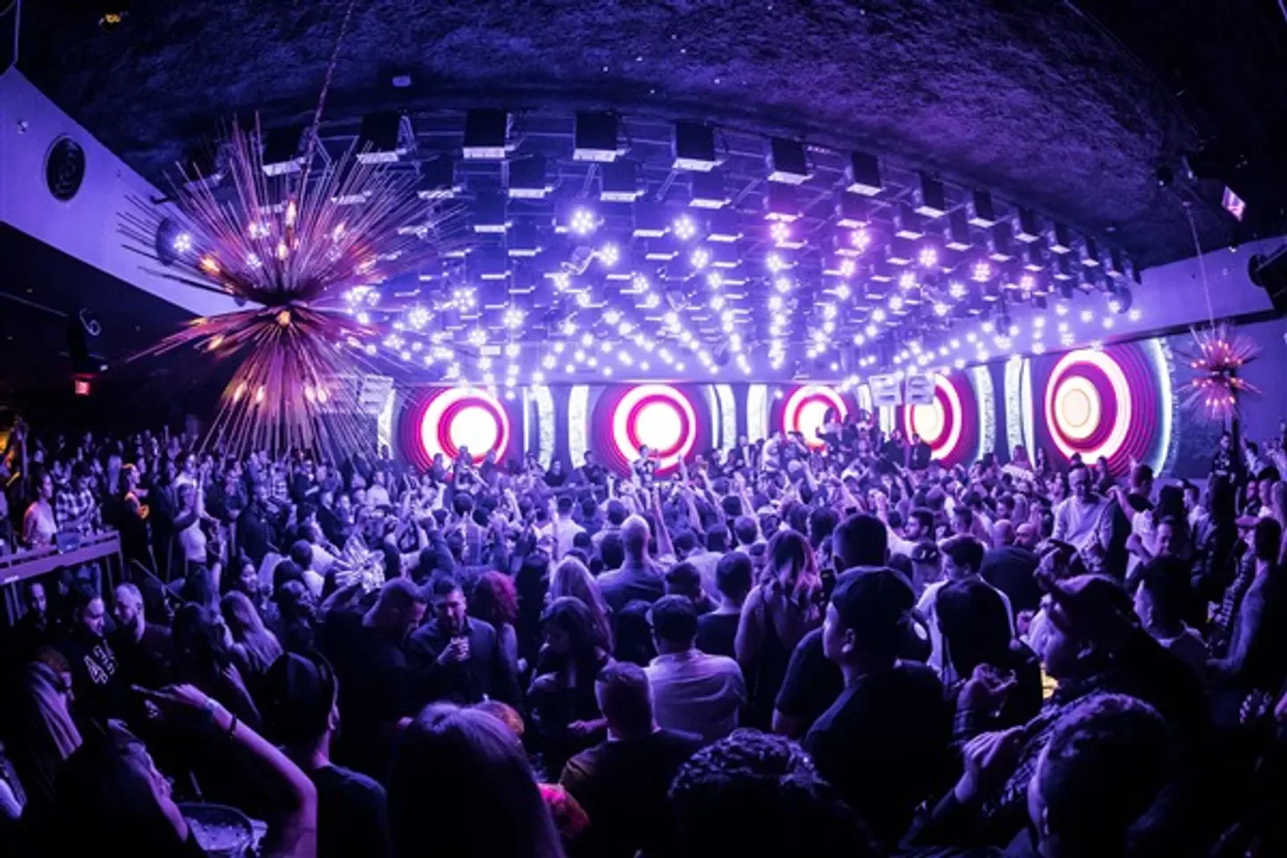 Energetic crowd at The Grand nightclub in Boston, enjoying a night out with lights.