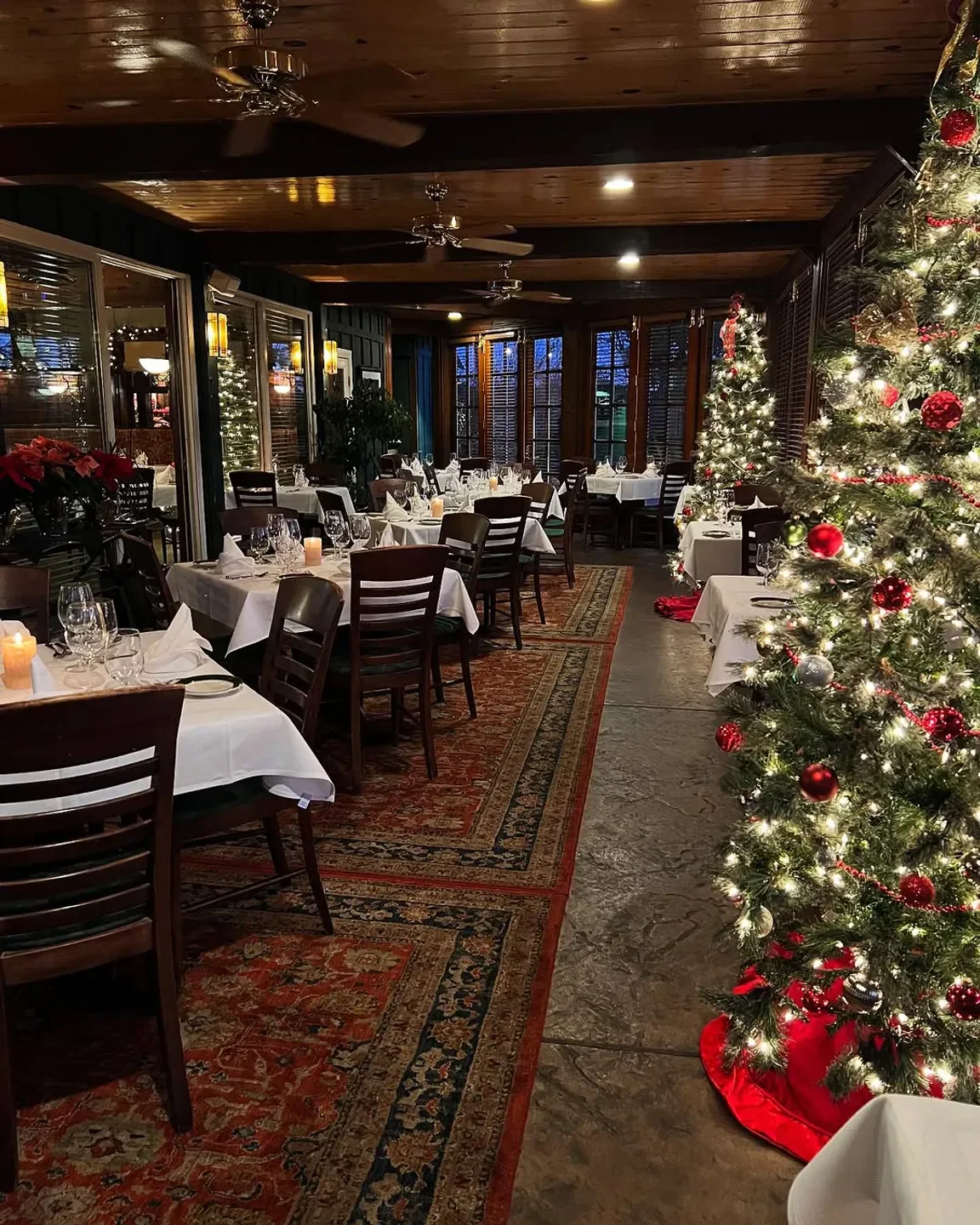 Festive dining room at The Greenbriar Inn in Boulder with Christmas tree.