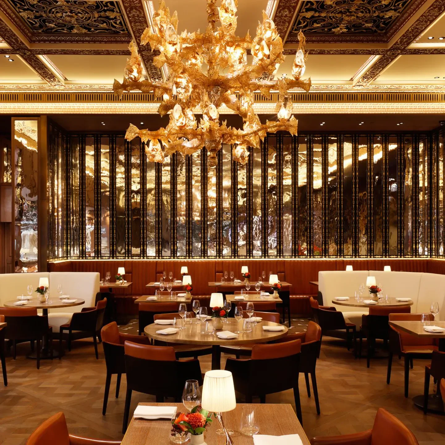Elegant dining room at The Grill by Tom Booton in London, with a golden chandelier.