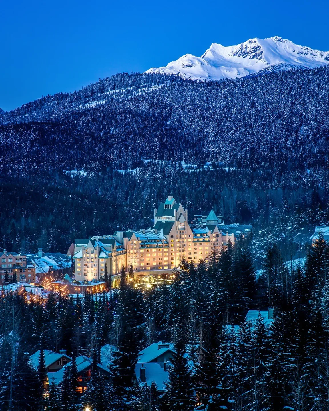 The Grill Room restaurant in Whistler, winter view with snow-covered trees and mountains.