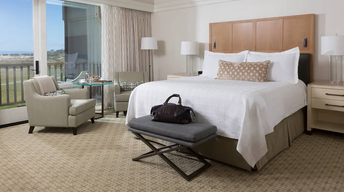 Cozy hotel room at The Inn at Spanish Bay in Monterey, featuring a relaxing balcony view.
