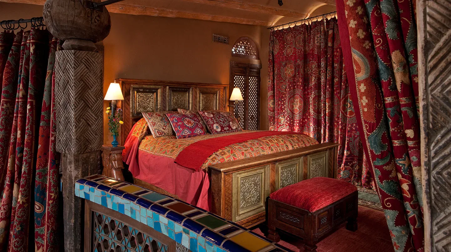 Cozy bedroom at The Inn of the Five Graces in Santa Fe, with unique decor and style.