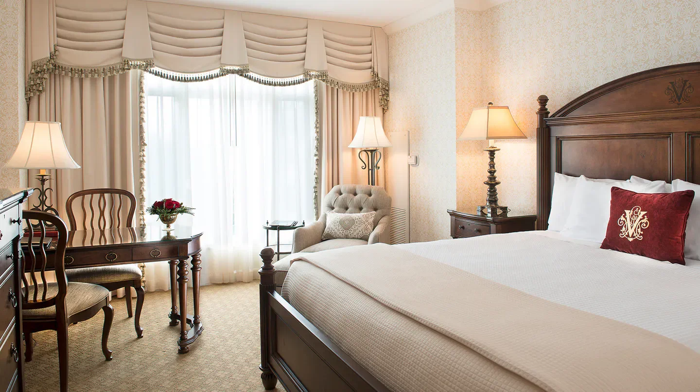 Cozy bedroom at The Inn on Biltmore Estate in Charlotte, featuring luxurious decor.