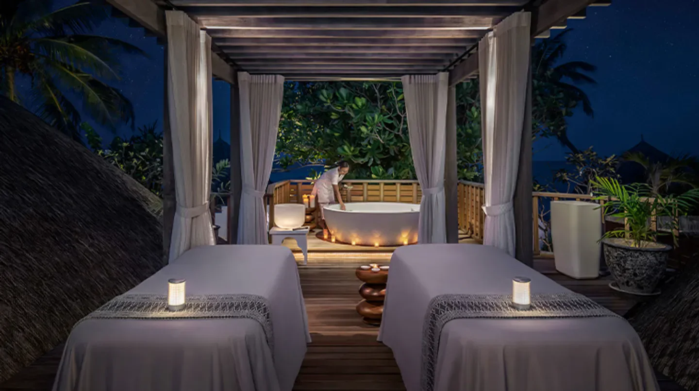 The Island Spa at Four Seasons Resort Maldives at Kuda Huraa spa setting in the Maldives at night.