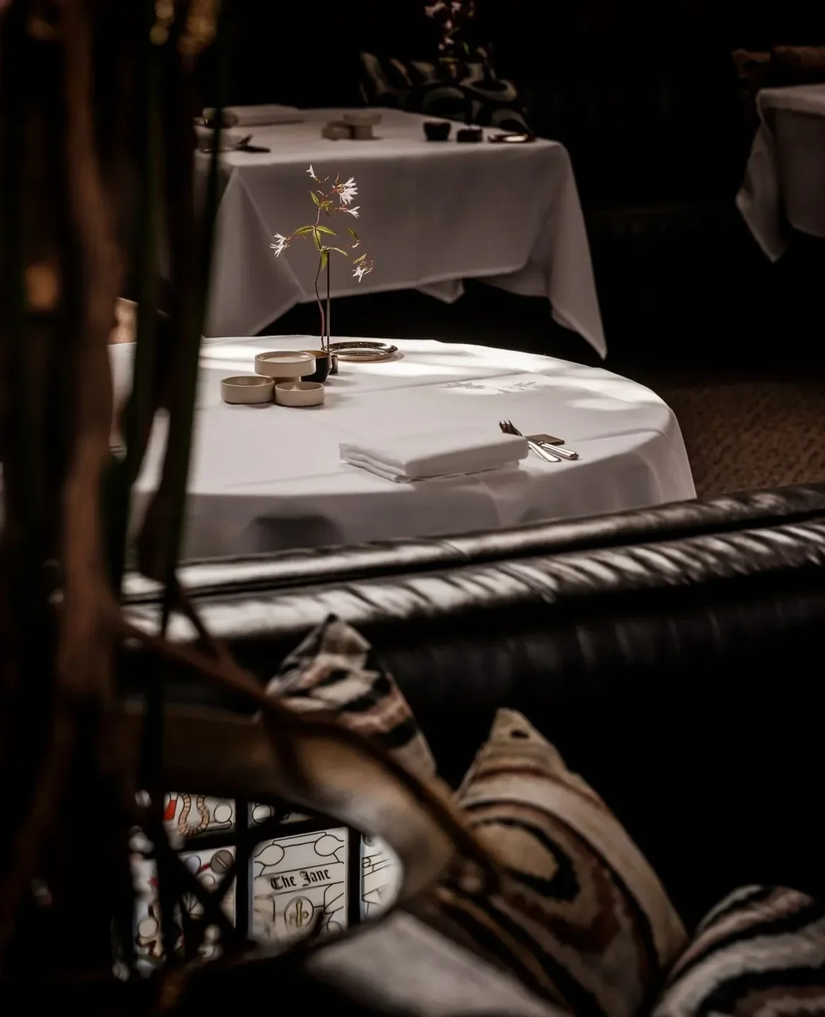 Elegant dining at The Jane in Antwerp, featuring a beautifully set table and decor.