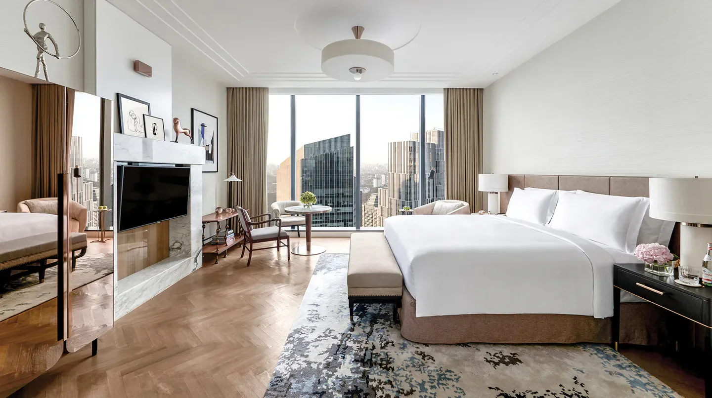 Luxury bedroom at The Langham, Jakarta, offering city views of Jakarta, Indonesia.